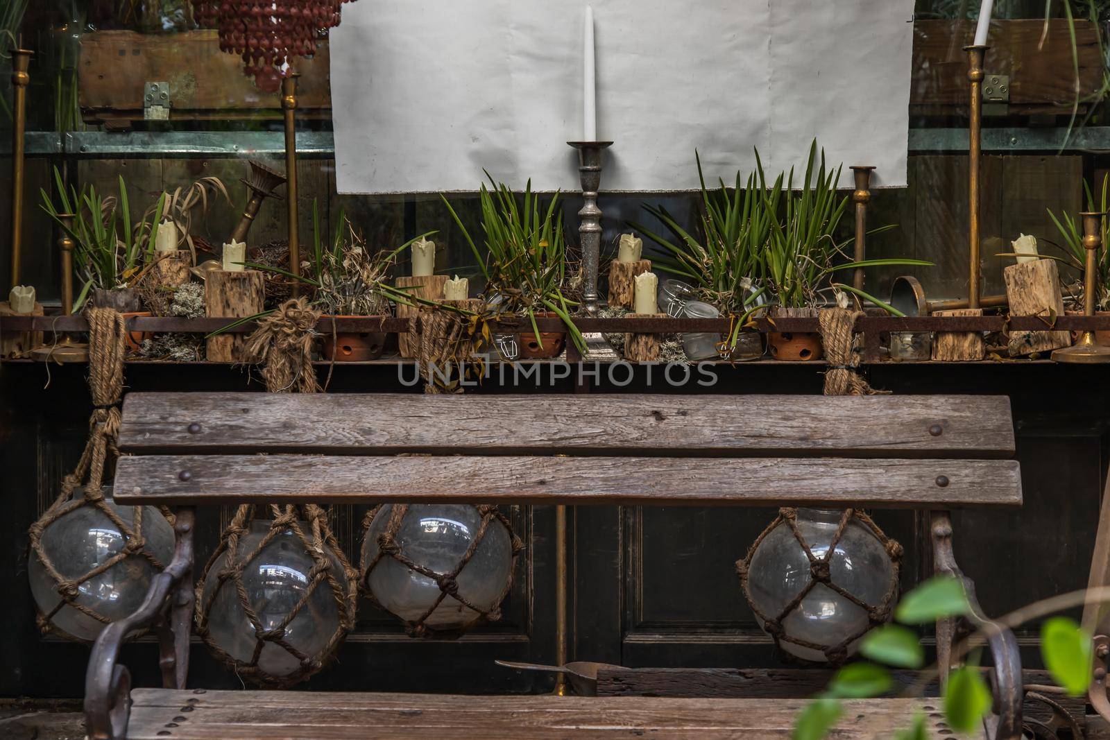 Candlestick and plant pot on wooden table with Wooden chair for sit back relax. Vintage house decoration idea, Selective focus.