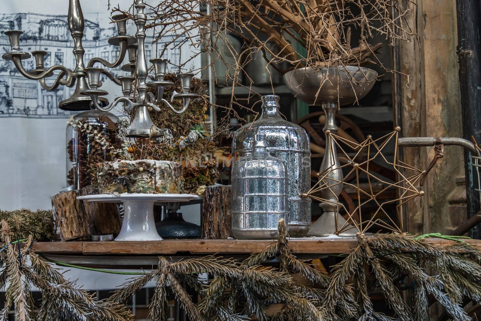 Antique candlestick and Dry plant, Dried flowers, Pine cones with Glass bottle Decorate on wooden table in cafe. Vintage shop decoration idea. Selective focus.