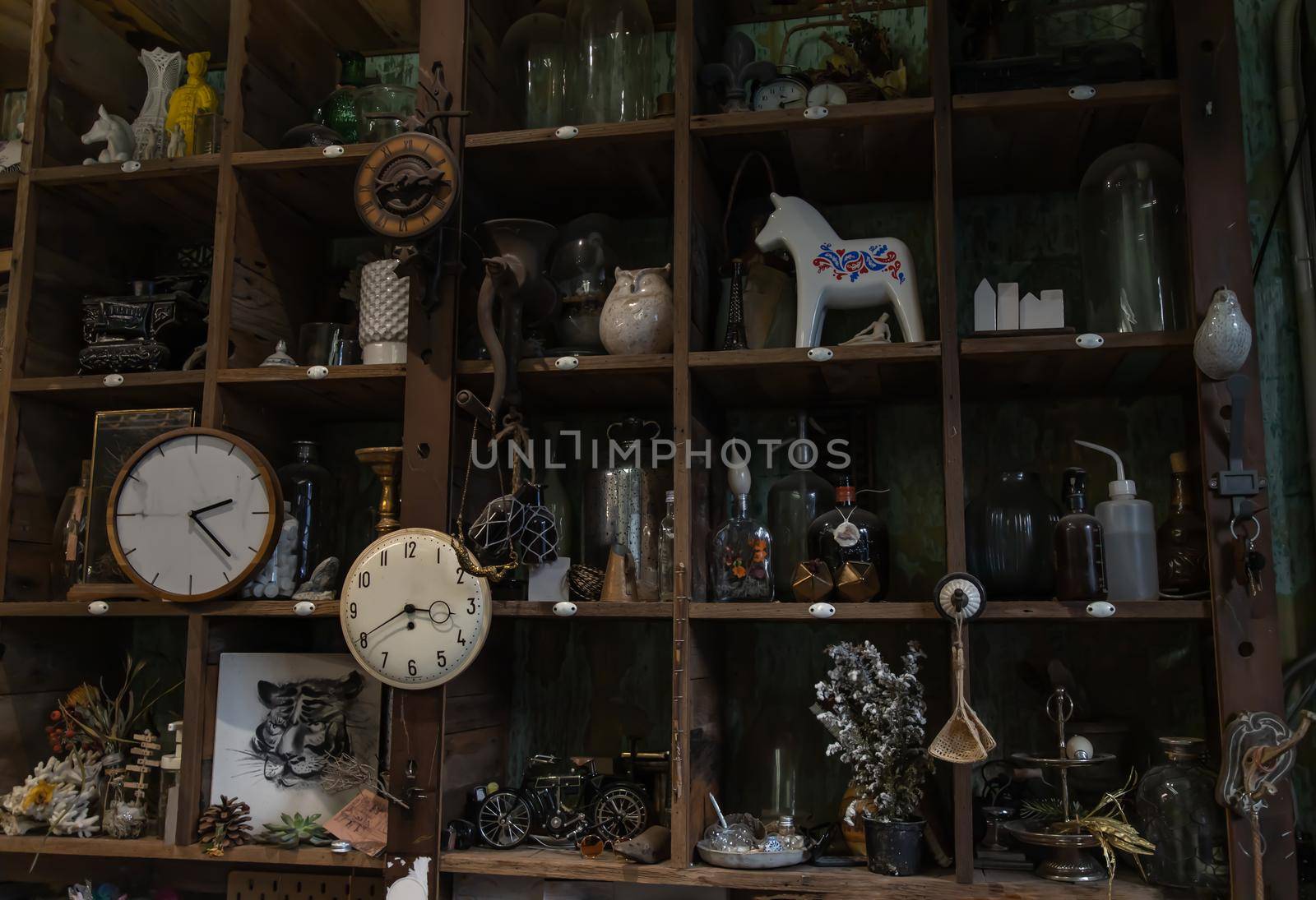 Bangkok, Thailand - Jun 26, 2020 : Wall clocks and Collectibles on handmade wooden rustic wall shelf in Living room Vintage style. No focus, specifically.