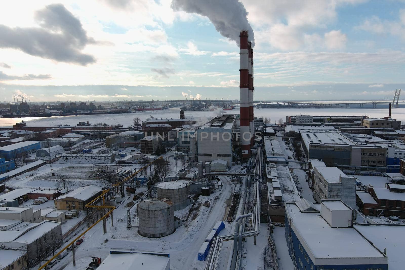 Steam from pipes of a thermal power plant over winter the city by vladimirdrozdin