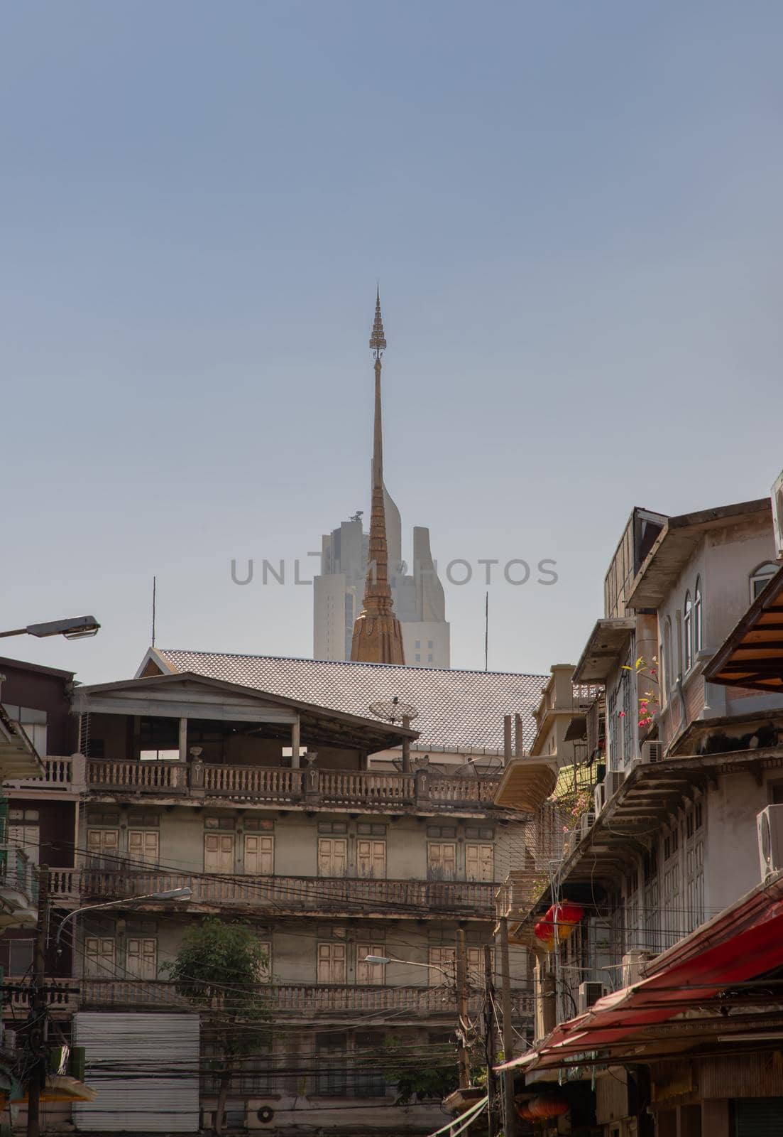 City view of Bangkok with House and Modern tall building and Thai temple that perfectly coexist. Selective focus.