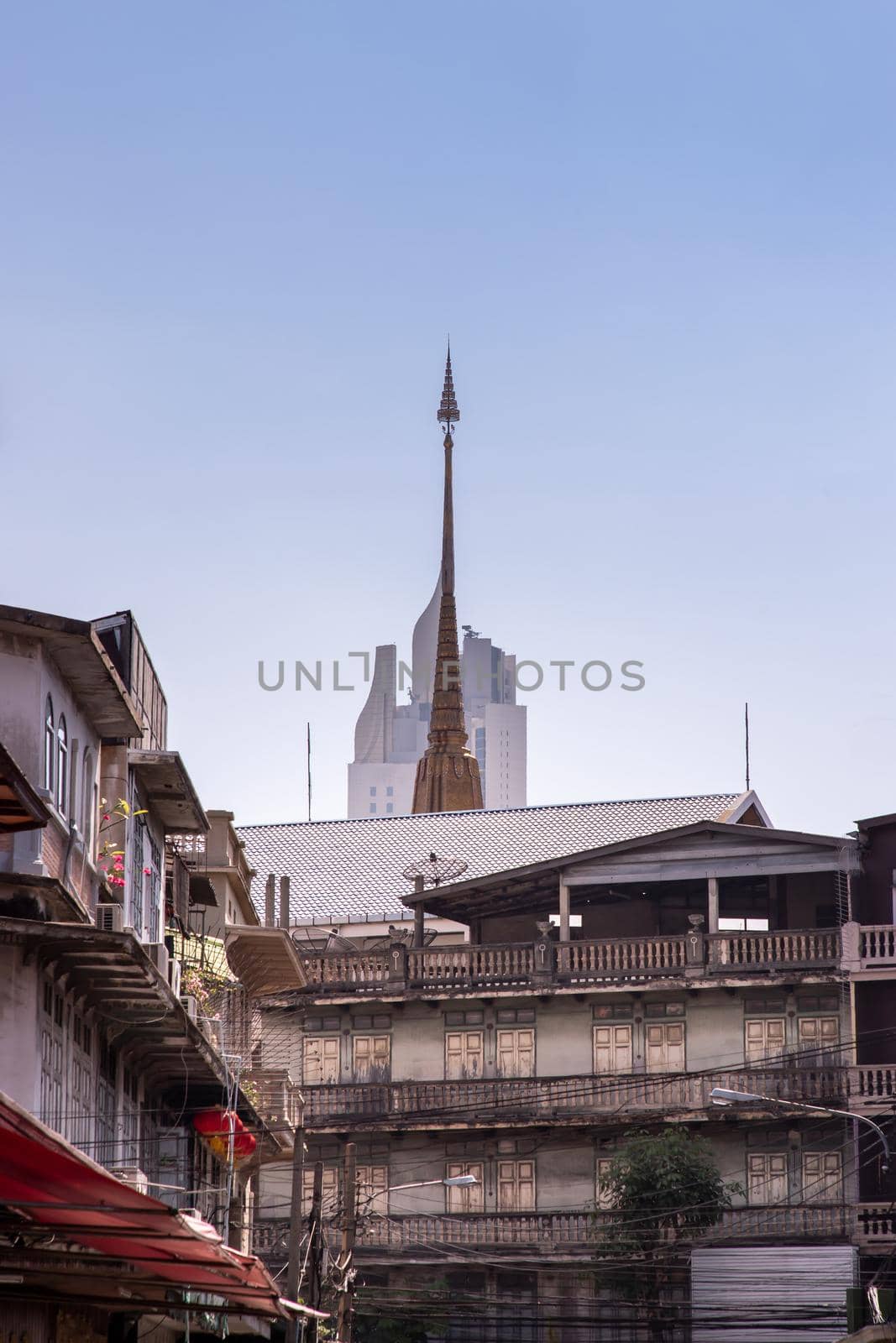 City view of Bangkok with House and Modern tall building and Thai temple that perfectly coexist. Selective focus.
