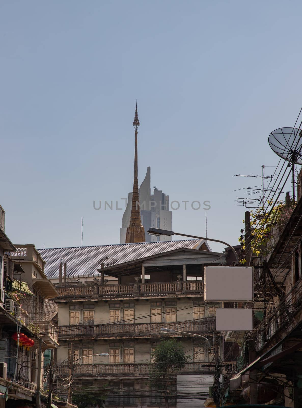 City view of Bangkok with House and Modern tall building and Thai temple that perfectly coexist. Selective focus.