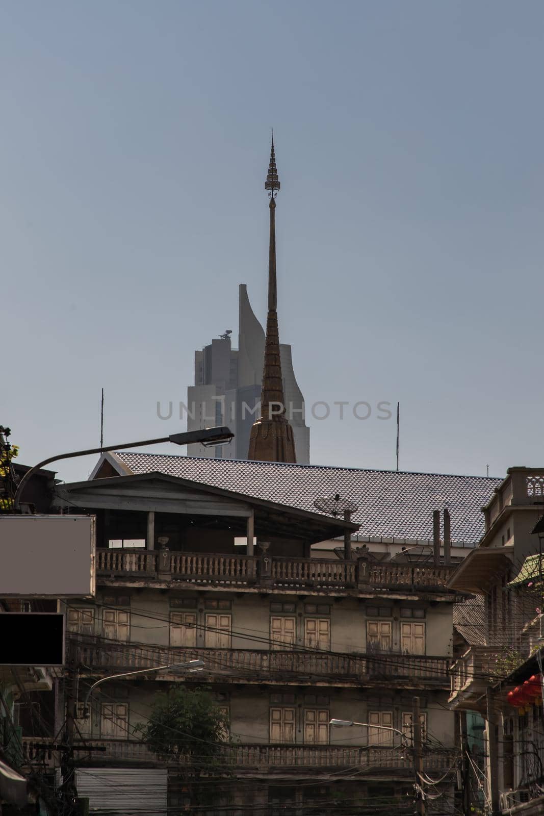 City view of Bangkok with House and Modern tall building and Thai temple that perfectly coexist. No focus, specifically.