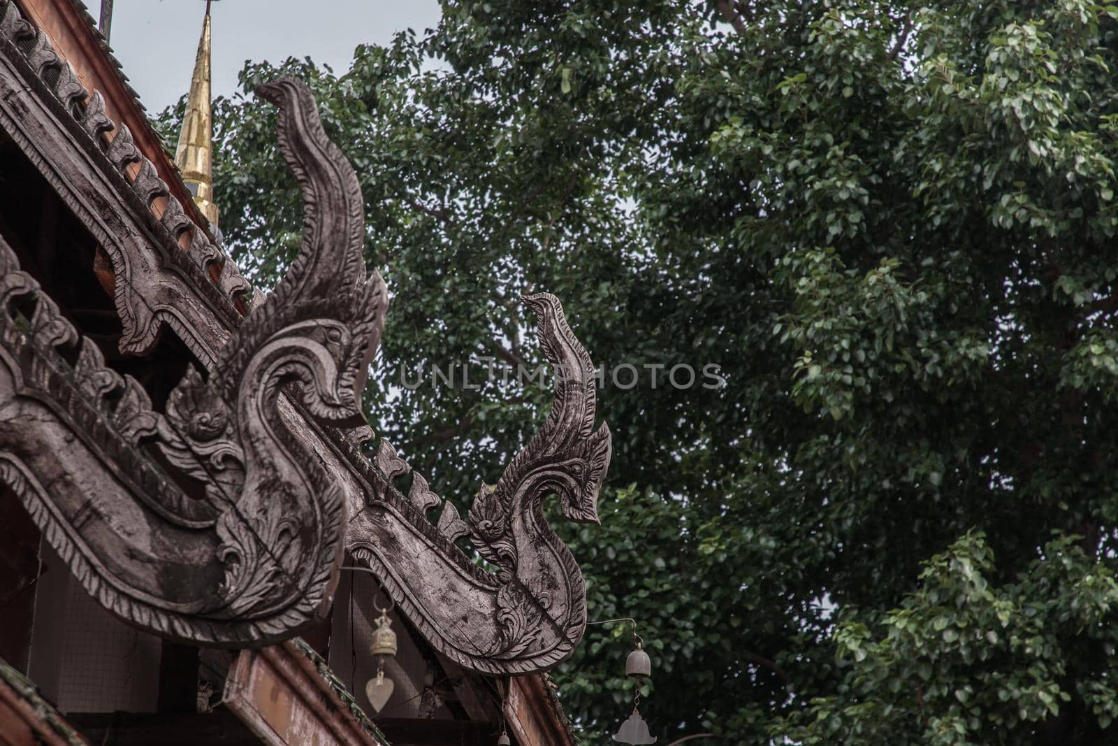 The Old wooden roof on Buddhist temple in Wat Pratu Pong at Lampang Province. An ancient temple decorated with ancient Lanna art, No focus, specifically.