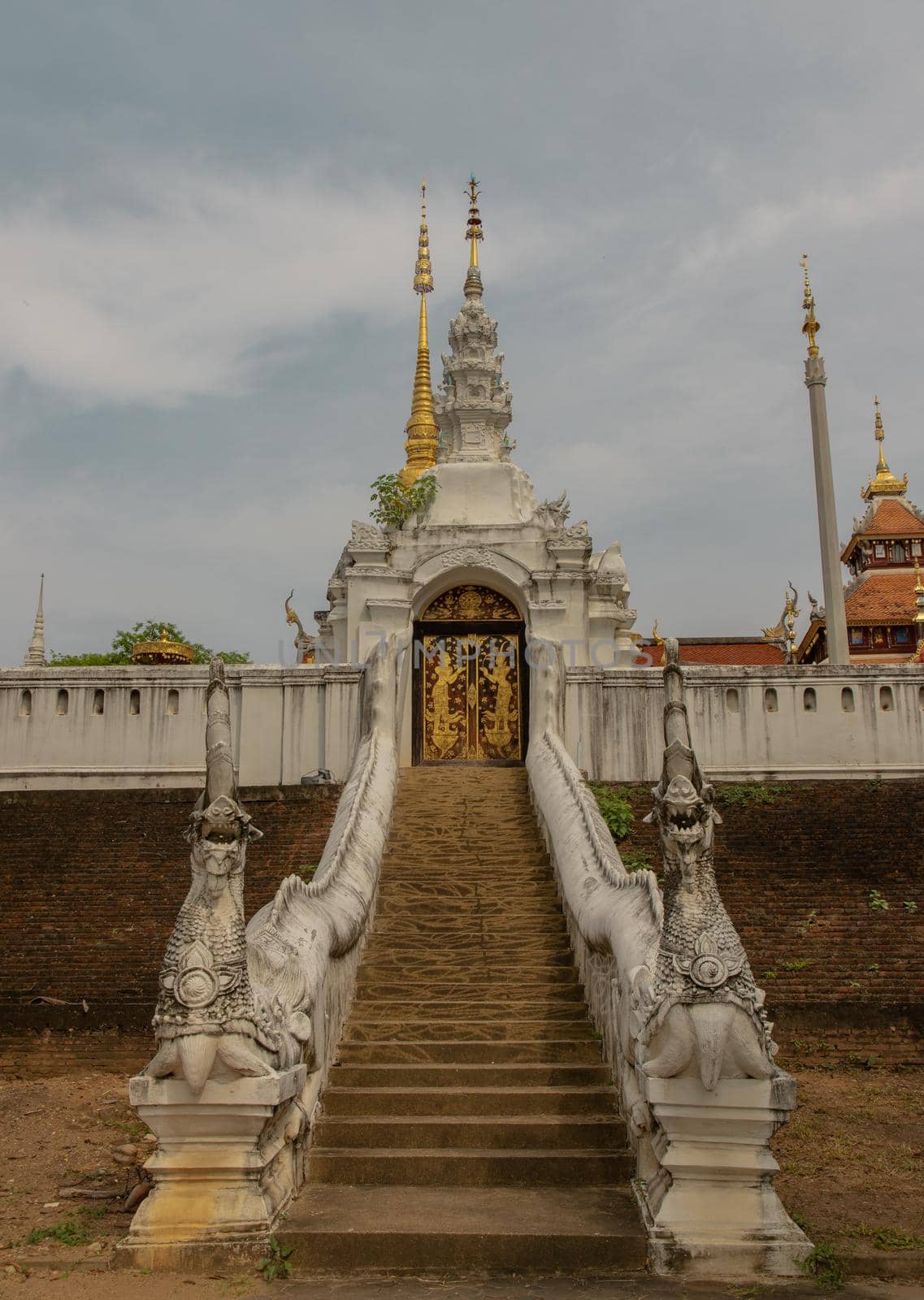 The way up to pay homage to Buddhist temple in Wat Pratu Pong at Lampang Province. Beautiful temple built in a mix of Lanna and Burmese Shan styles. Selective focus.