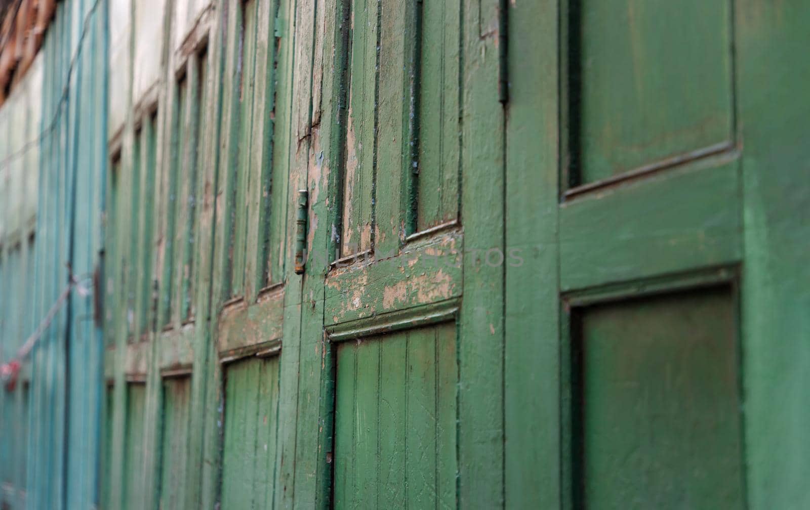 Green vintage wooden door old ancient traditional of home asia. Retro architecture exterior building. Selective focus.