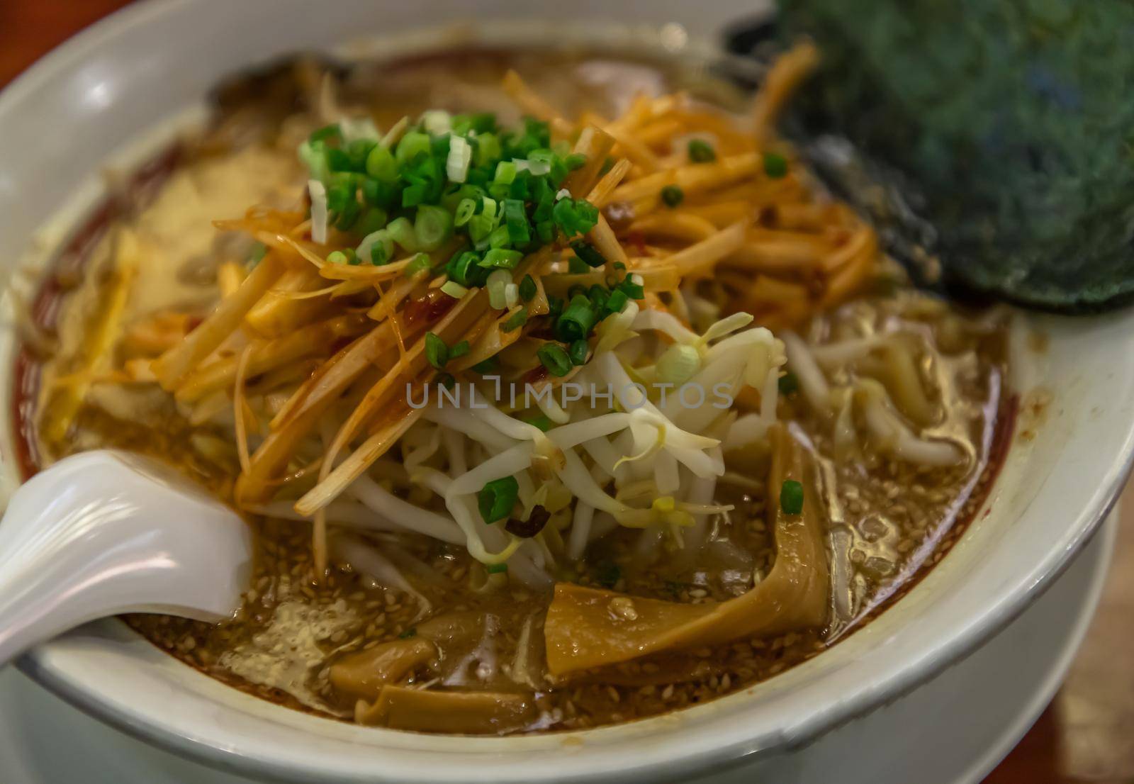 Japanese soup ramen served with chashu pork, Japanese bamboo shoots and sauteed bean sprouts, japanese leek sprinkled with thai spring onions. Japanese food style, Selective focus.