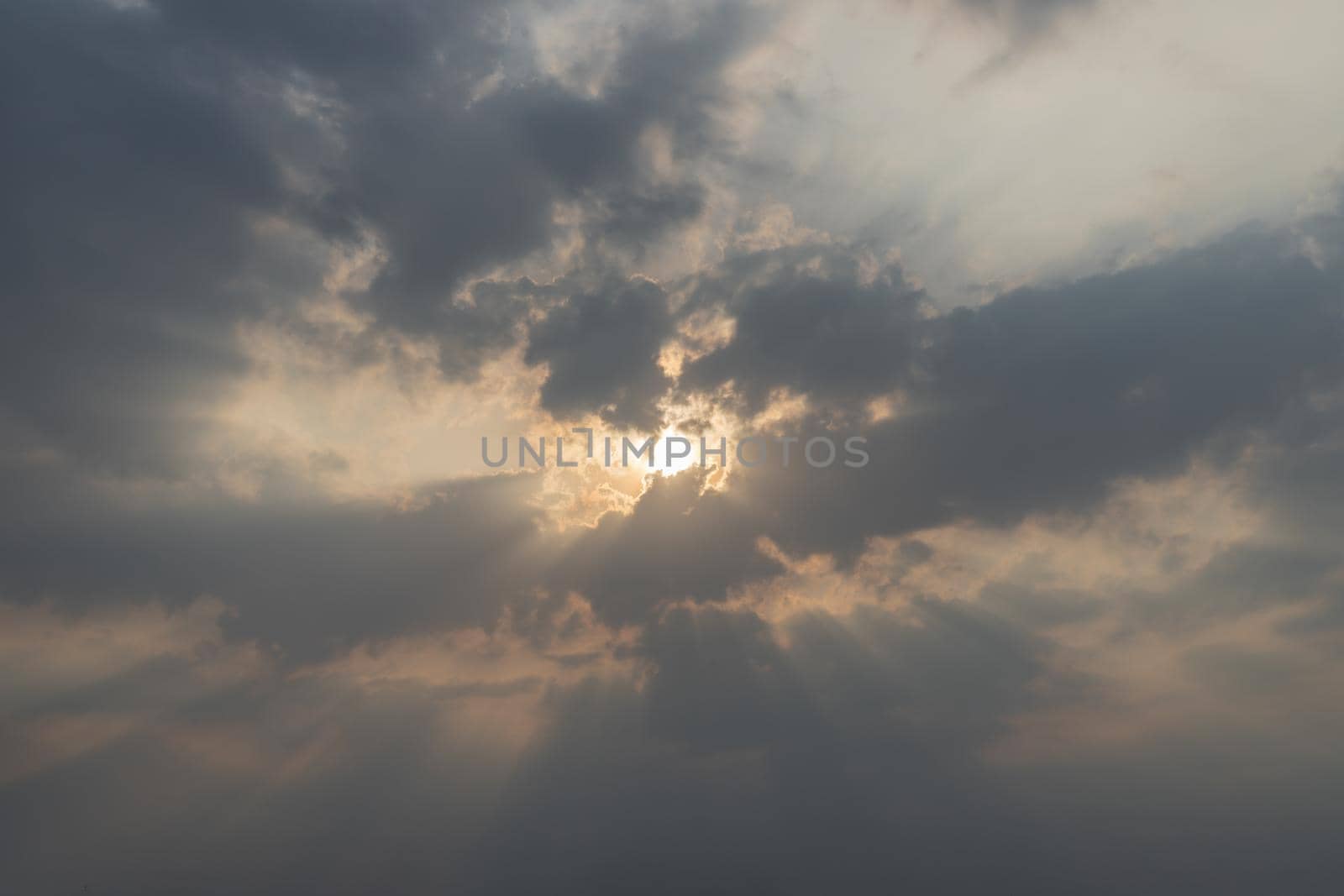 Beautiful evening blue sky. Sun's rays shine through in clouds. natural background. Inspirational concept. Copy space.