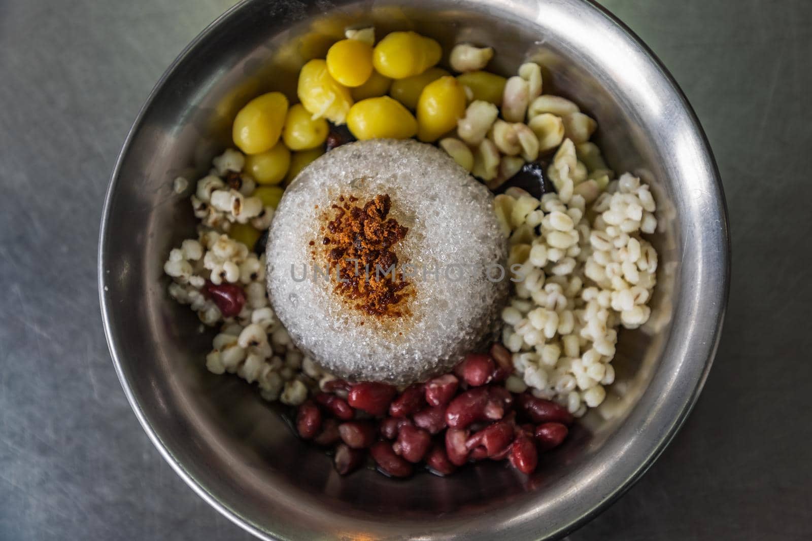Grass Jelly and cold red beans, ginkgo, millet served with ice in Silver bowl. Thai dessert, Very popular street food in Thailand. Top view. Selective focus.