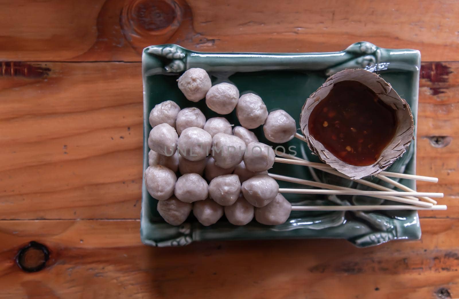 thai style pork ball grilled served with spicy-sweet dipping sauce. It is a delicious appetizer. Top view, Copy space, Focus and blur.