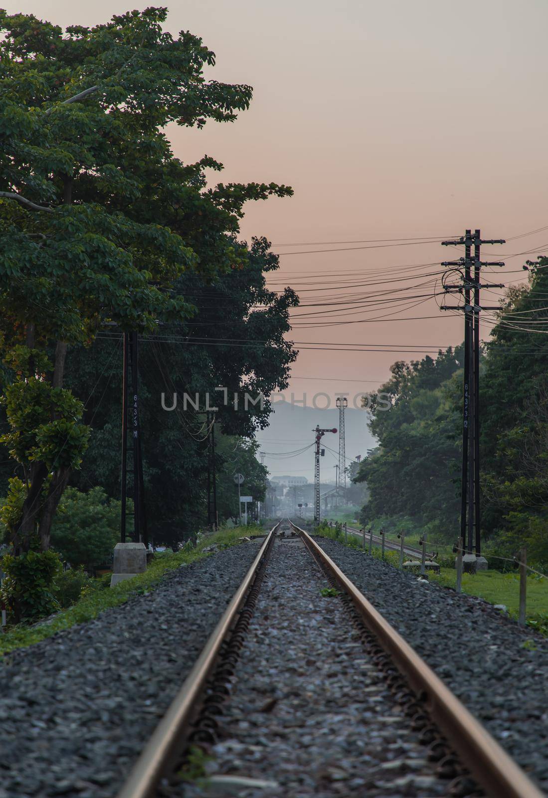 Old railroad train tracks in the countryside against beautiful sky in nature. Transport and shipping landscape concept. Selective focus.