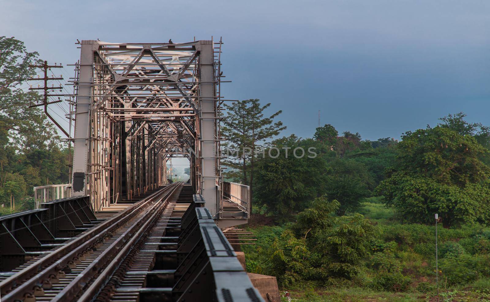 Old railroad tracks on Black Bridge or Lampang Railway Bridge. Railway bridge on river at Lampang thailand. No focus, specifically.
