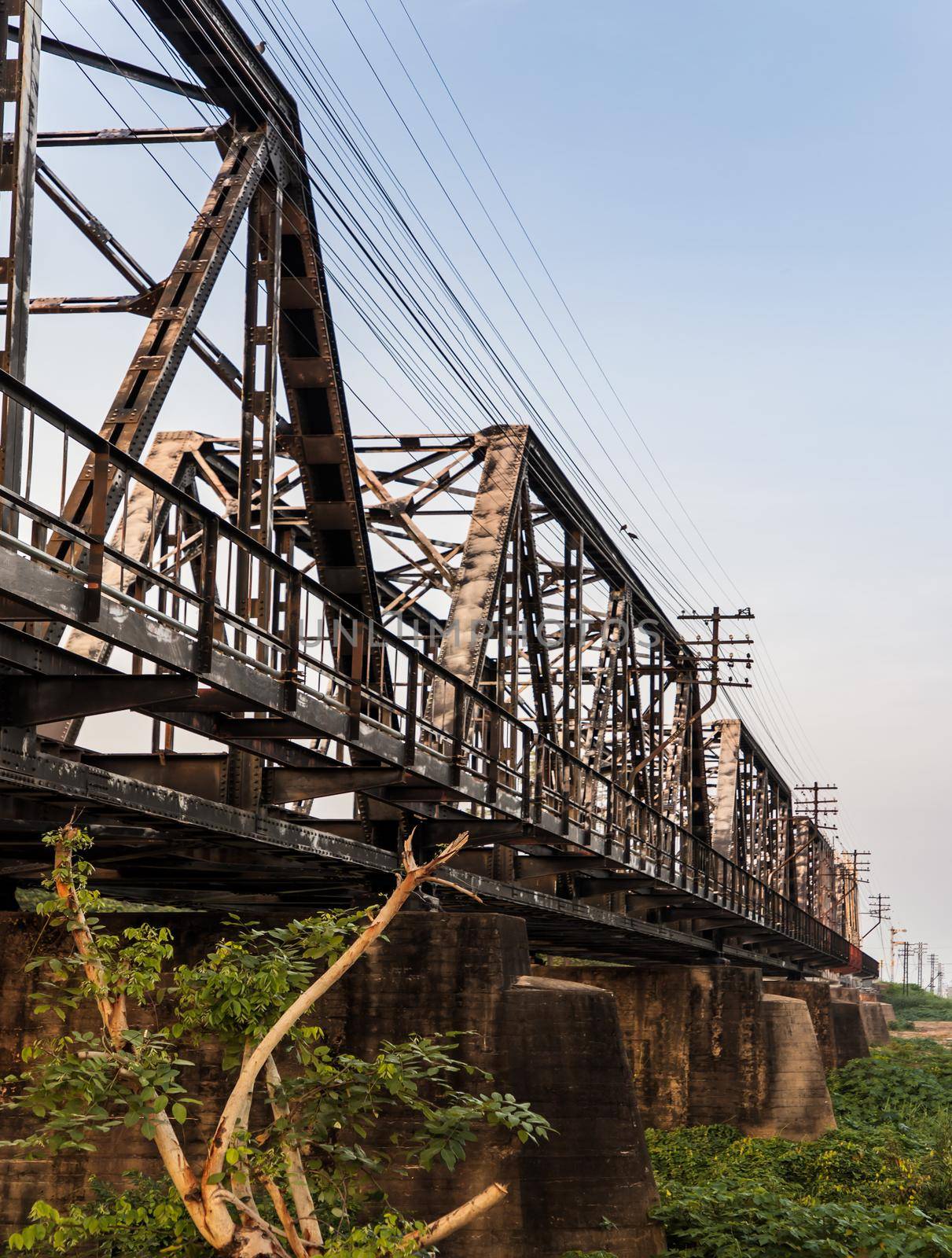 Old railroad tracks on Black Bridge or Lampang Railway Bridge. Railway bridge on river at Lampang thailand. No focus, specifically.