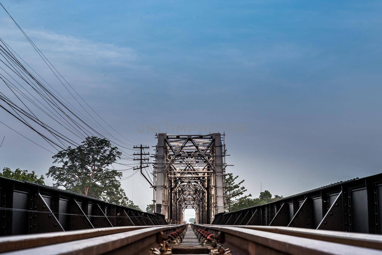 Old railroad tracks on Black Bridge or Lampang Railway Bridge. Railway bridge on river at Lampang thailand. Selective focus.