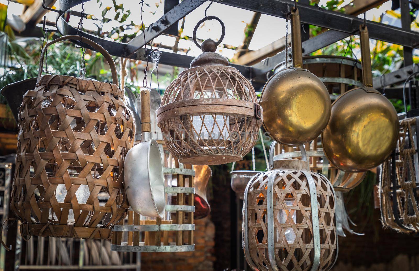 Cooking utensils hanging on Iron railings in the kitchen. kitchen appliances, No focus, specifically.