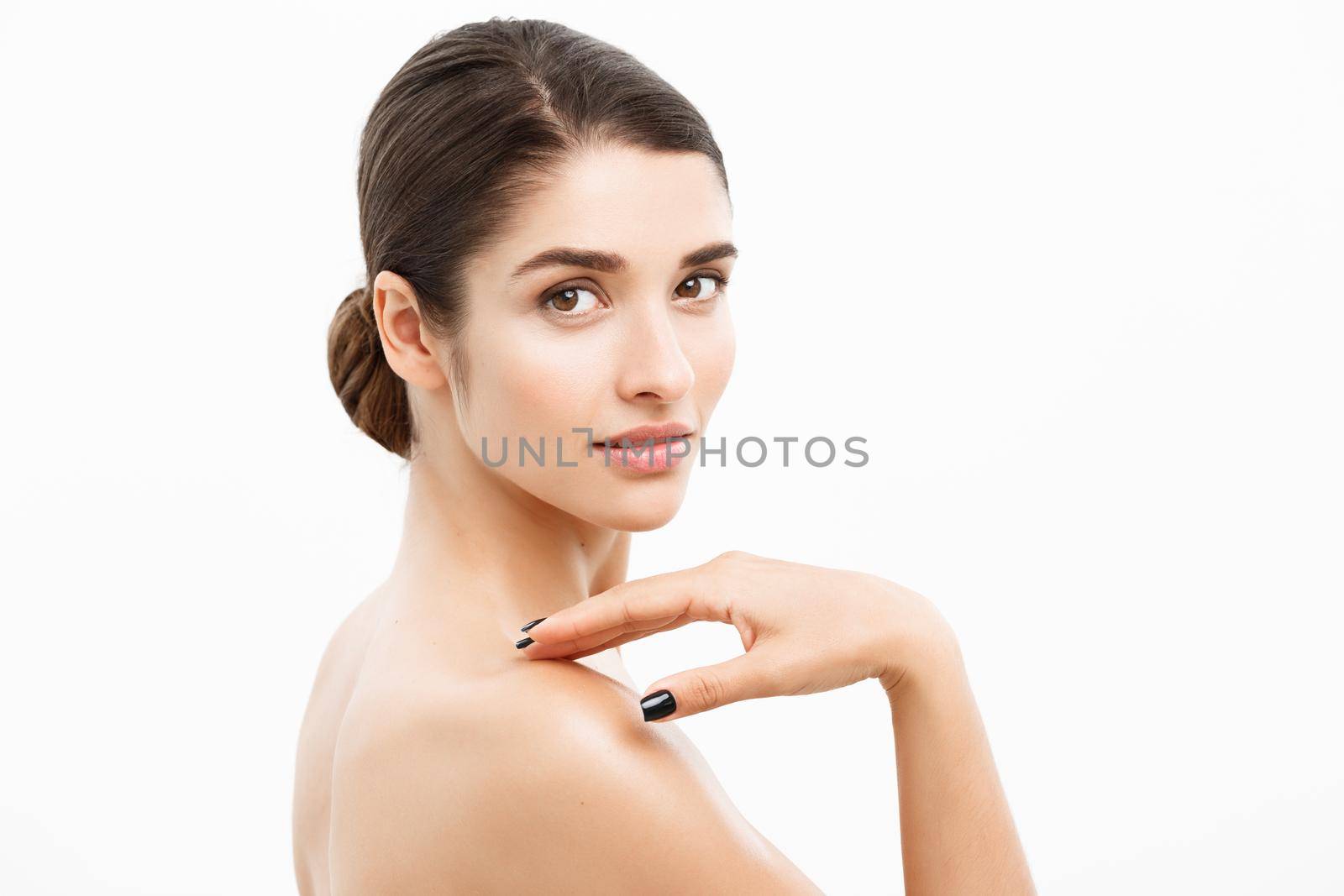 Beauty and Skin care concept - Close up Beautiful Young Woman touching her skin on white background