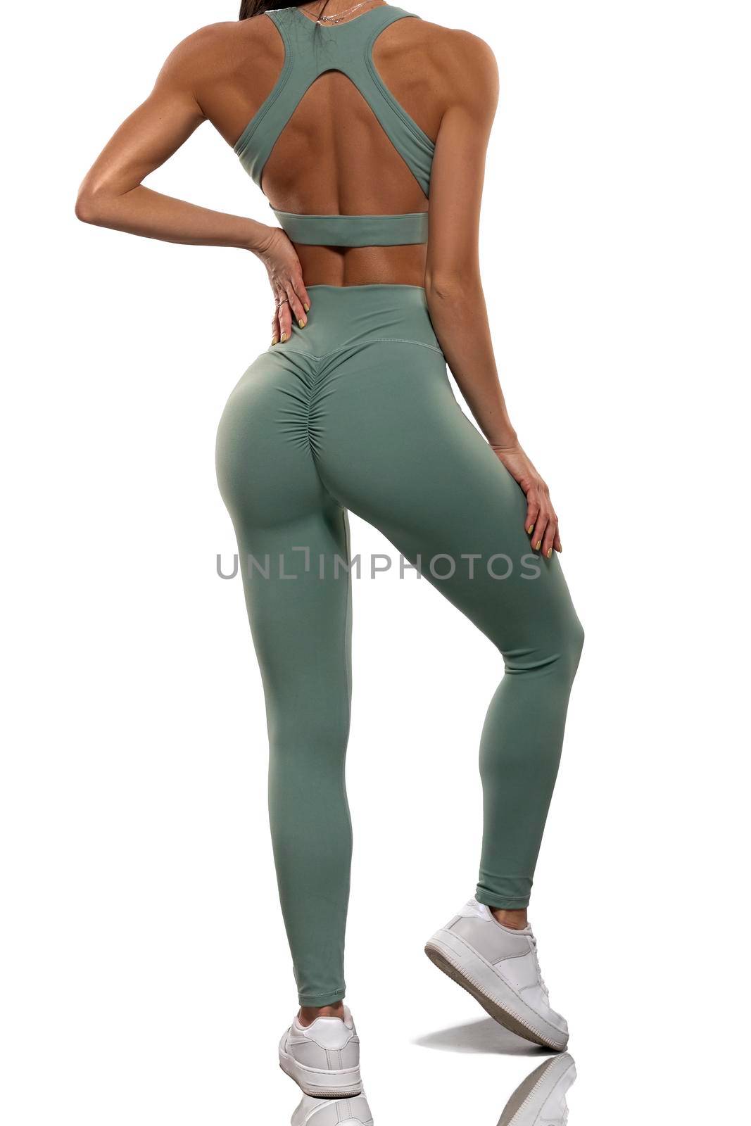 legs girl in olive leggings and top stay back on a white background by but_photo