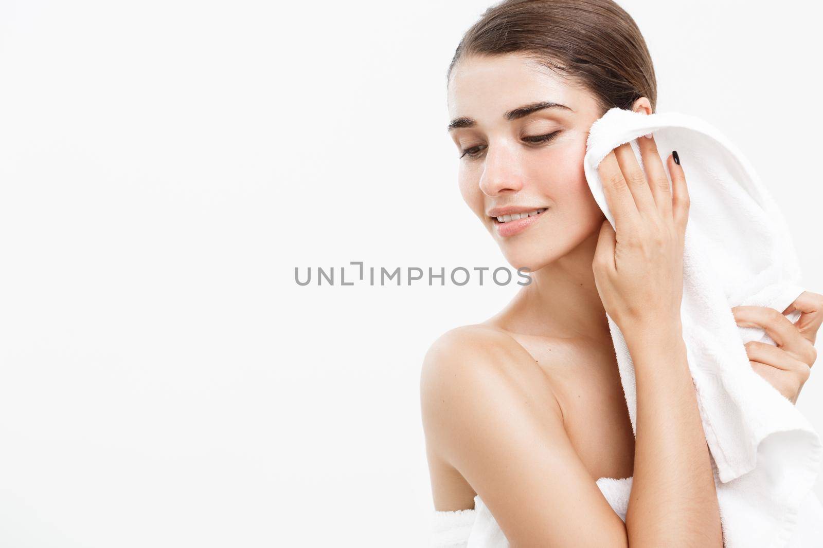 Beauty Skin Care Concept - Beautiful Caucasian Woman Face Portrait. Beautiful beauty young female model girl smooth cleaning her face over white background