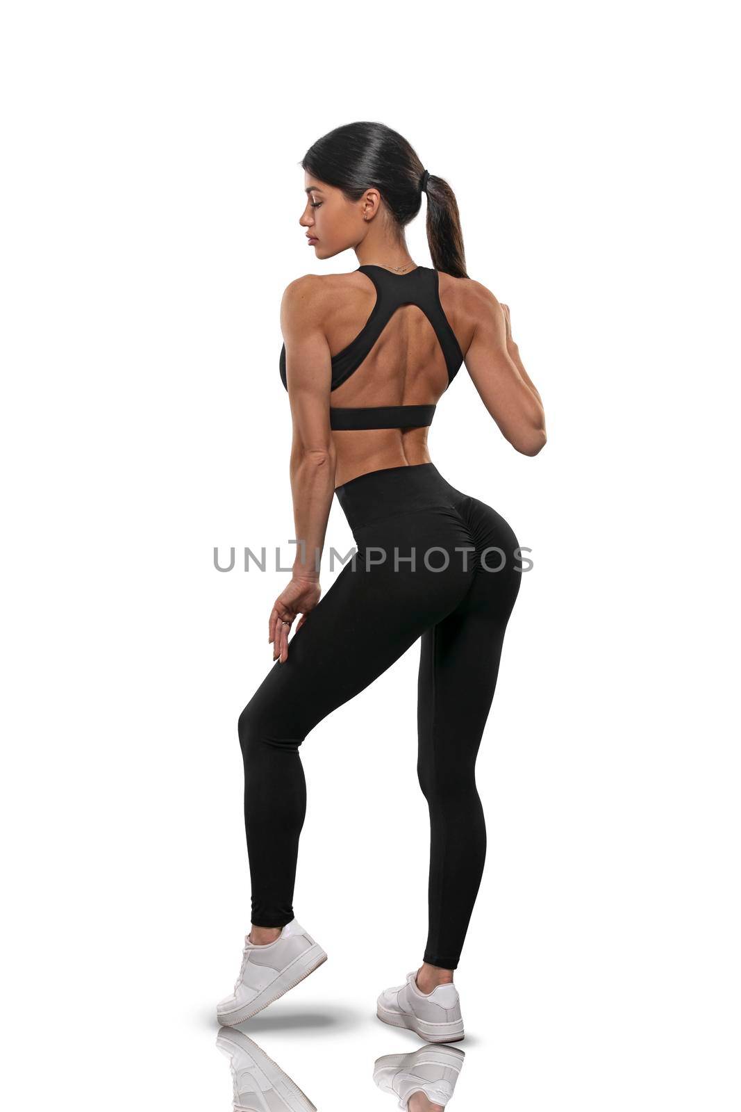 girl in black leggings and a top stay back on a white background by but_photo