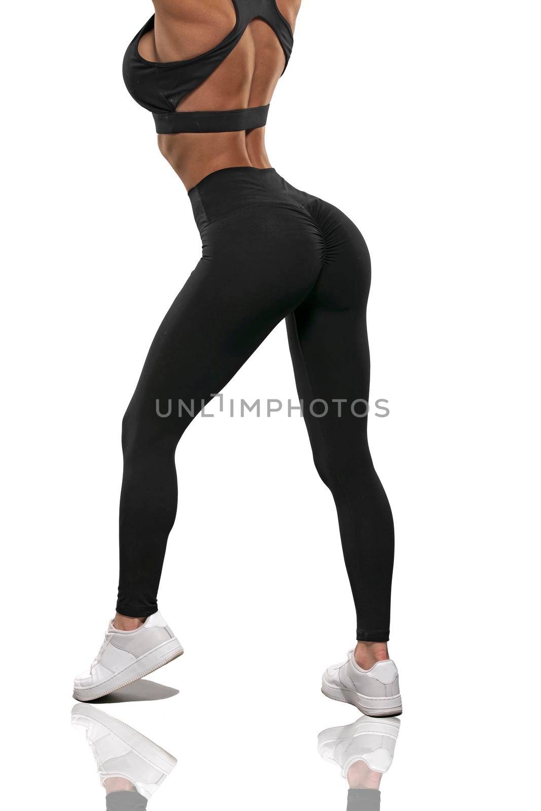 legs girl in black leggings and a top stay back on a white background by but_photo