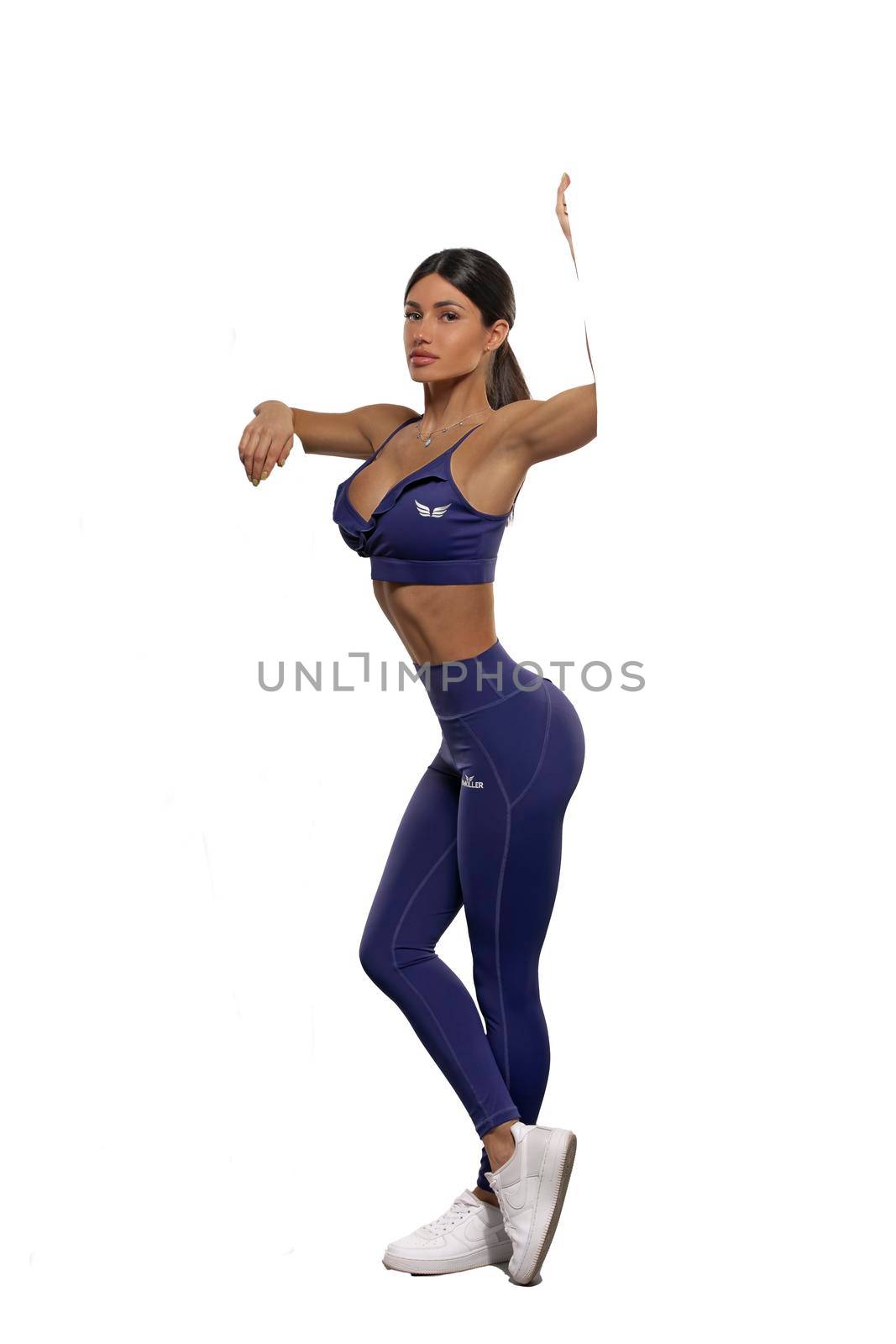 brunette girl in blue leggings and top on a white background