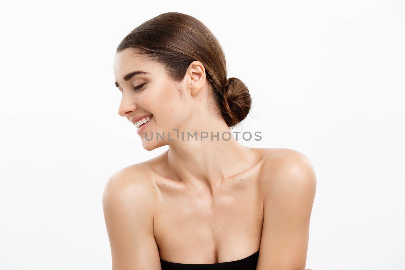 Health care and spa concept - attractive young and healthy woman with nude makeup on white background