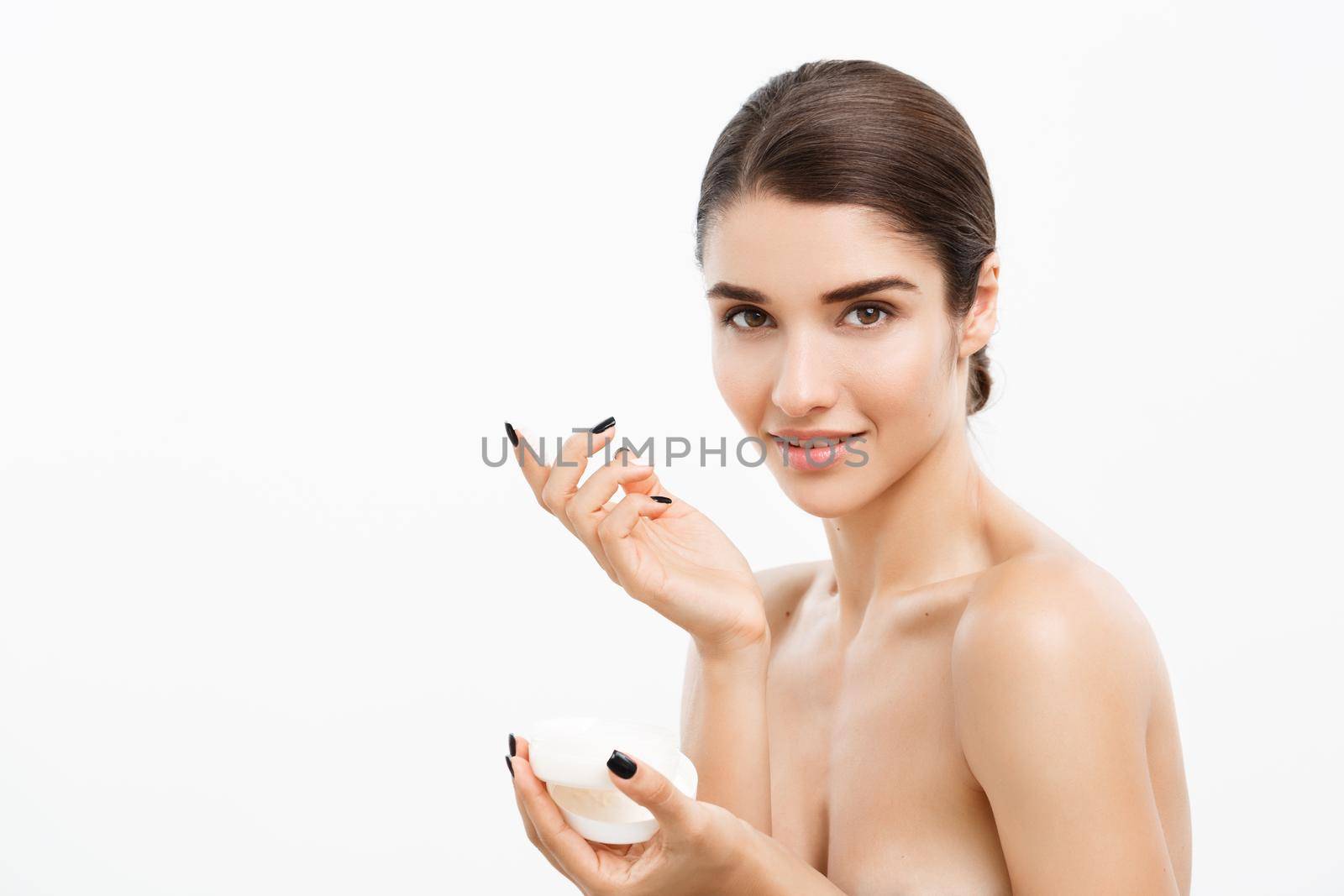 Beauty Youth Skin Care Concept - Beautiful Caucasian Woman Face Portrait smiling and holding cream jar for body and skin.Isolated over white background