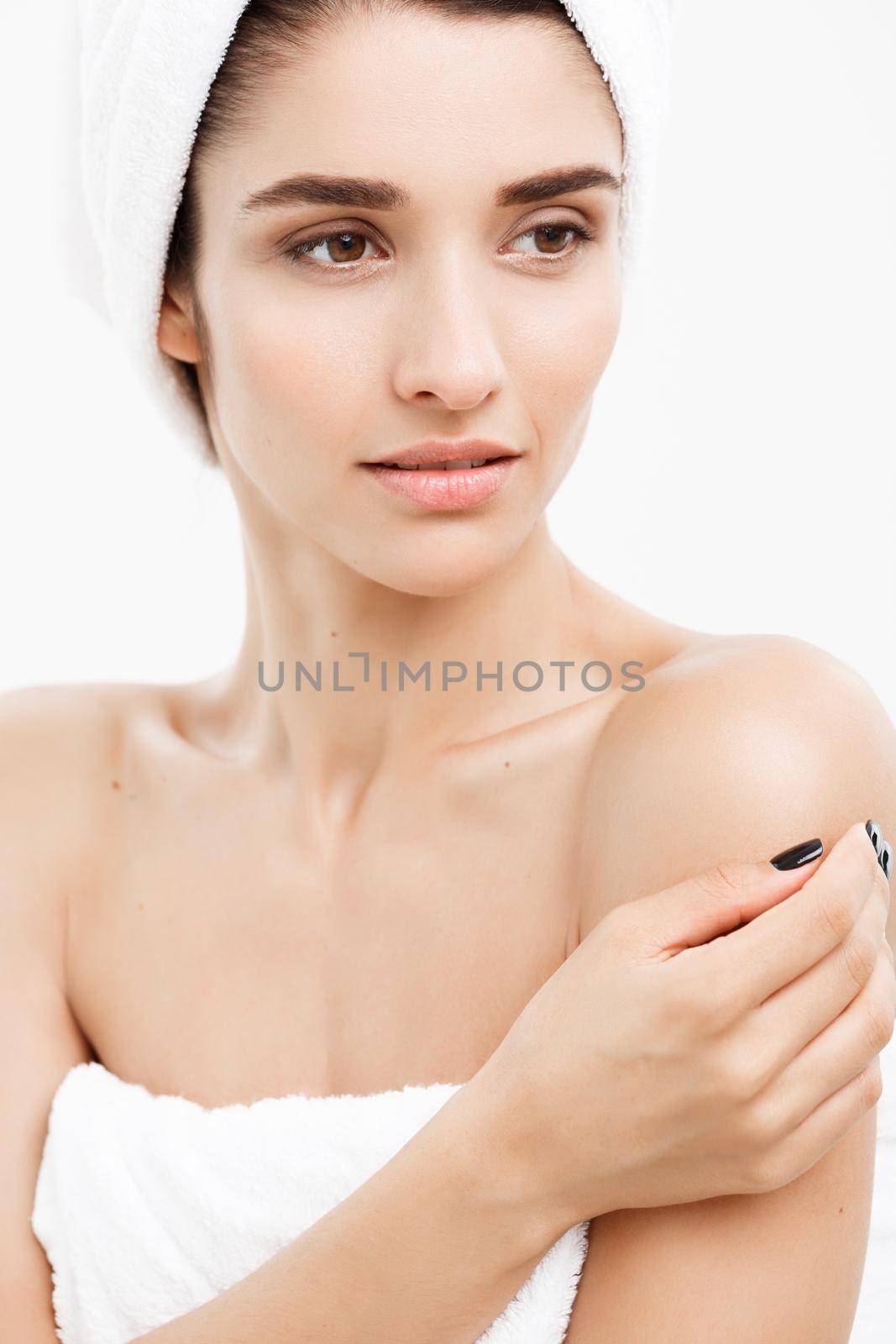 Beauty and Skin care concept - Close up Beautiful Young Woman touching her skin.