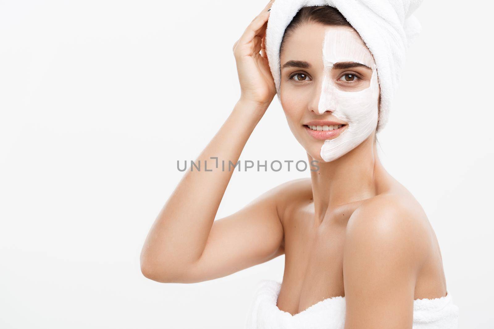 Beauty Skin Care Concept - Beautiful Caucasian Woman Face Portrait applying cream mask on her facial skin white background