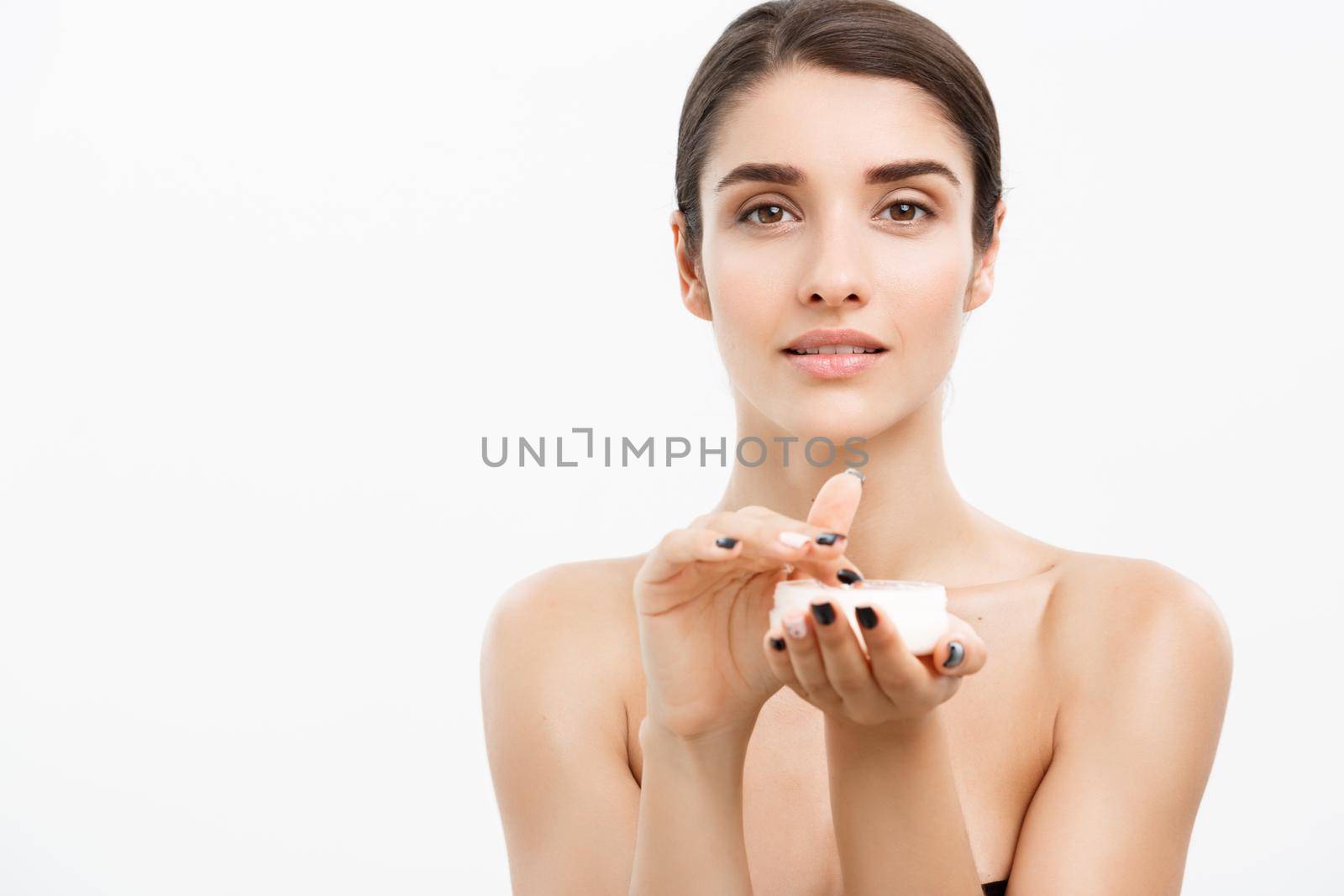 Beauty Youth Skin Care Concept - Beautiful Caucasian Woman Face Portrait smiling and holding cream jar for body and skin.Isolated over white background