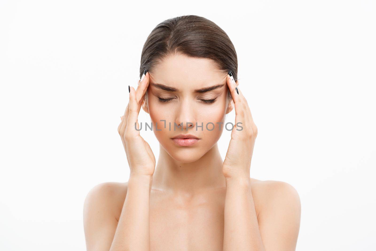 Beauty Skin Care Concept - Beautiful Caucasian Woman Face Portrait. Beautiful beauty young female model girl touching her face with stress feeling over white background