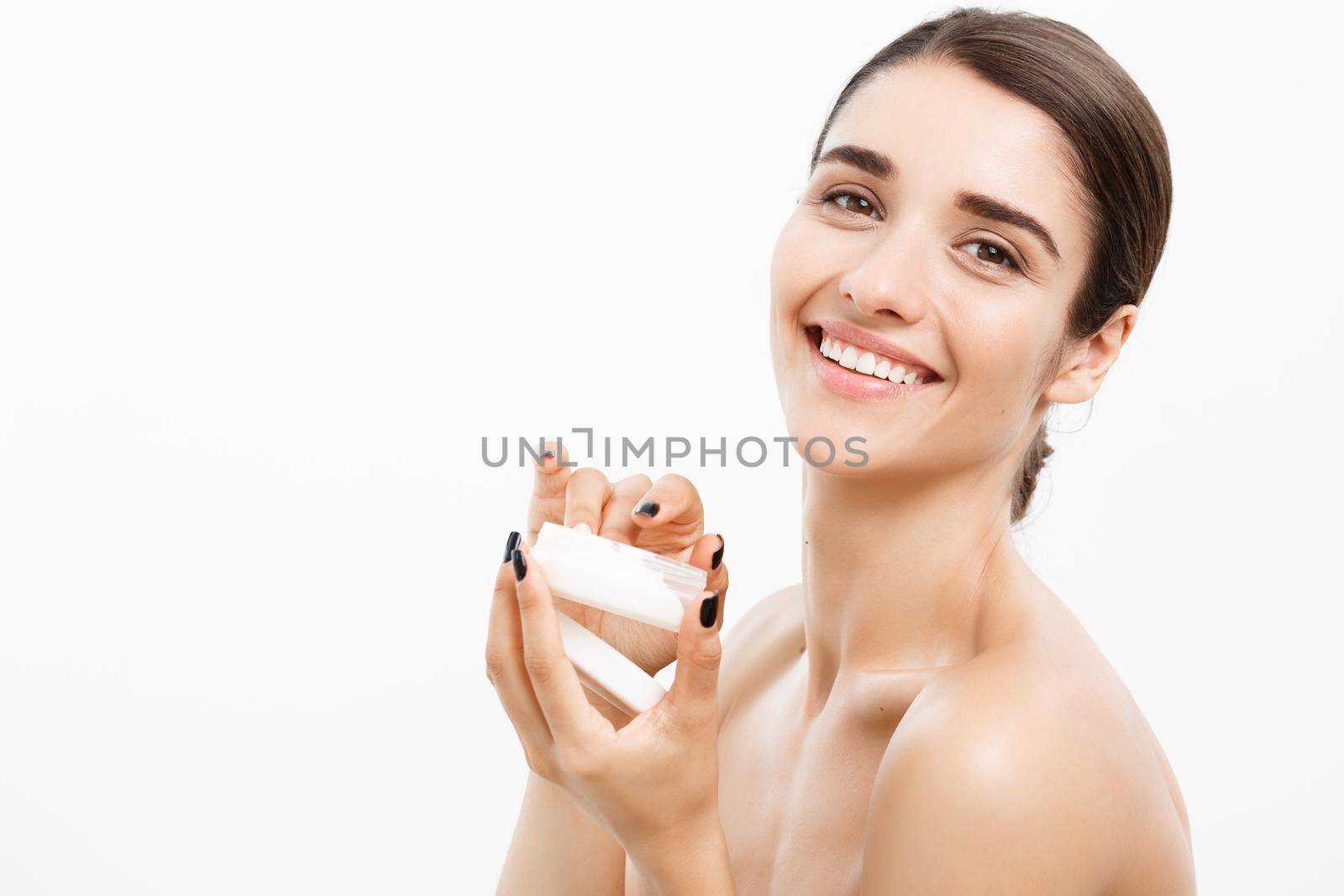 Beauty Youth Skin Care Concept - Beautiful Caucasian Woman Face Portrait smiling and holding cream jar for body and skin.Isolated over white background