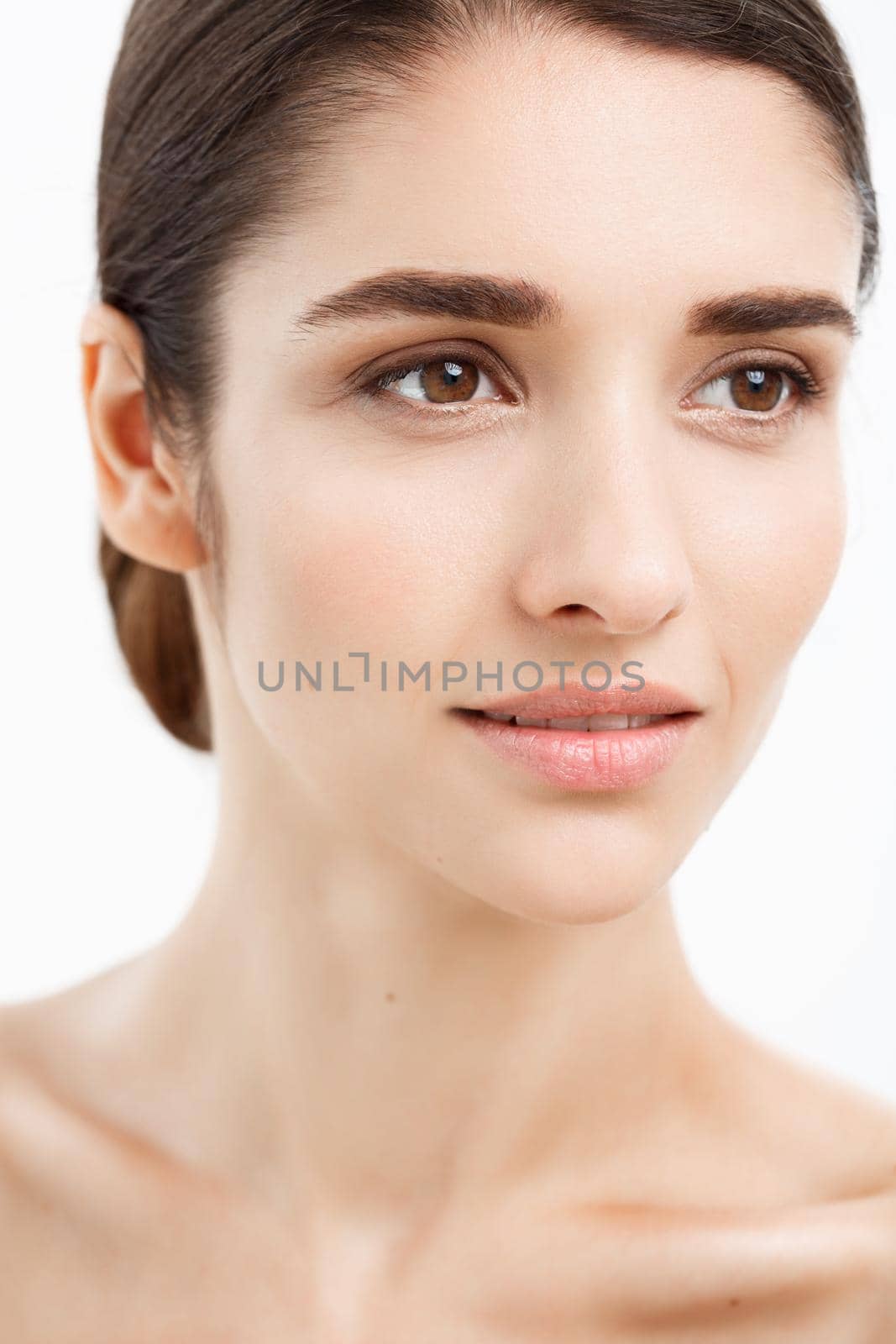 Beauty Youth Skin Care Concept - Close up Beautiful Caucasian Woman Face Portrait. Beautiful Spa model Girl with Perfect Fresh Clean Skin over white background. by Benzoix