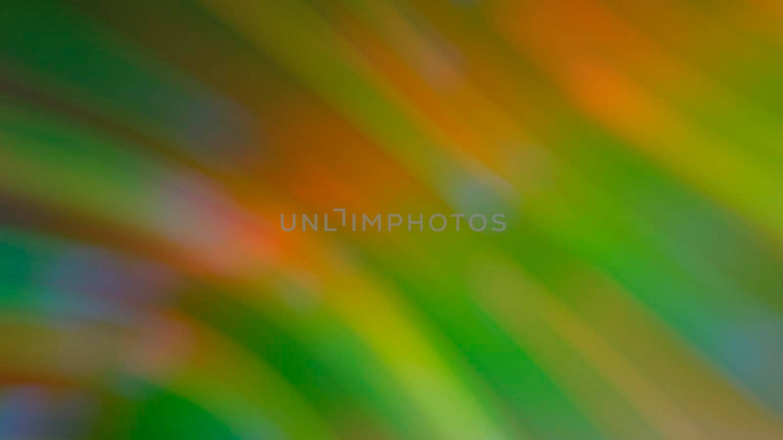 Abstract blurry green background with rainbow highlights.