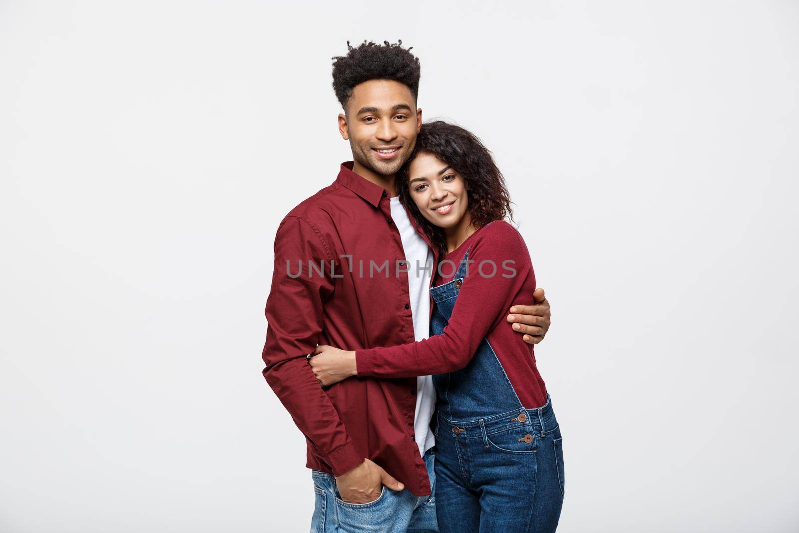 portrait of happy african american couple hug each other on white background