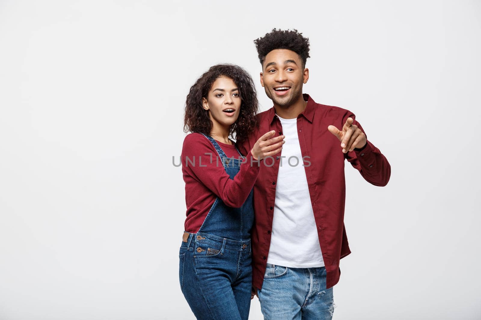 Young African American people in casual clothes looking away and point finger. isolated on white background by Benzoix