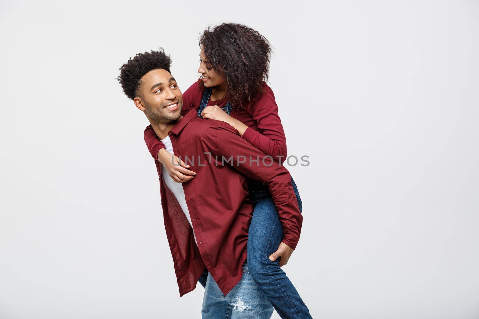 Close-up young african american couple enjoy riding back. by Benzoix