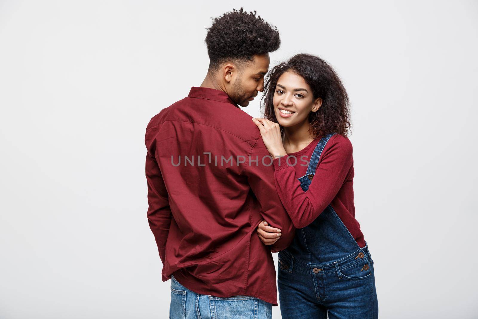 portrait of happy african american couple hug each other on white background