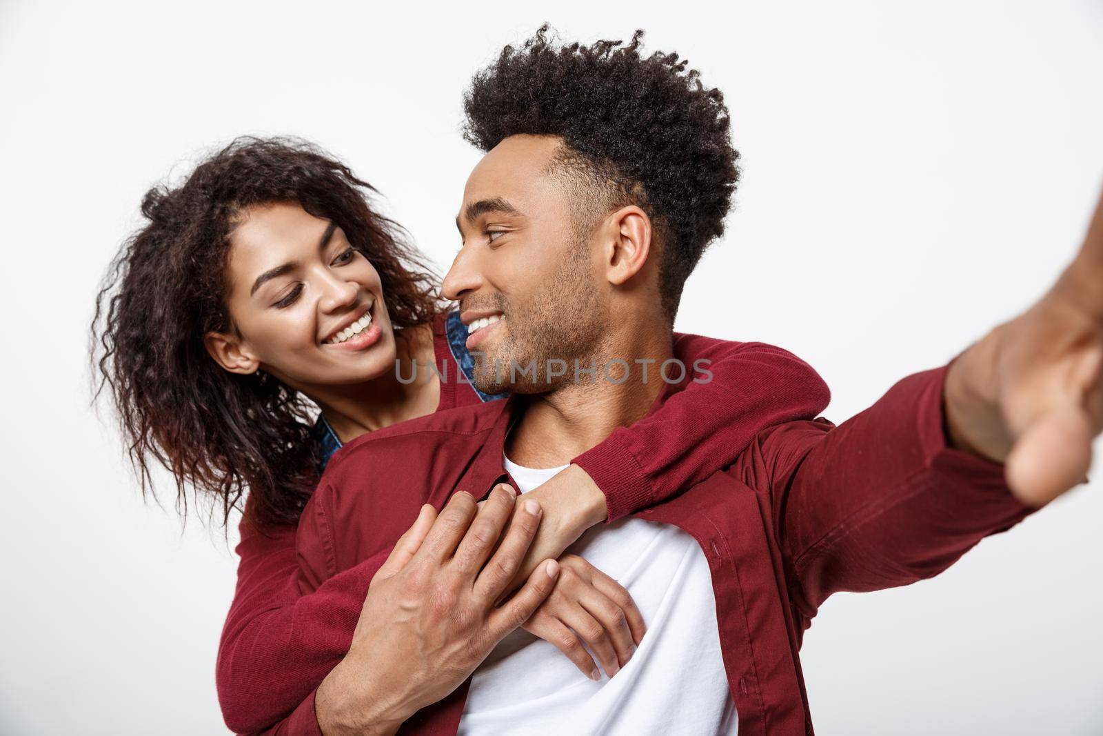 Close up attractive African American couple making a selfie with cute gesture. by Benzoix