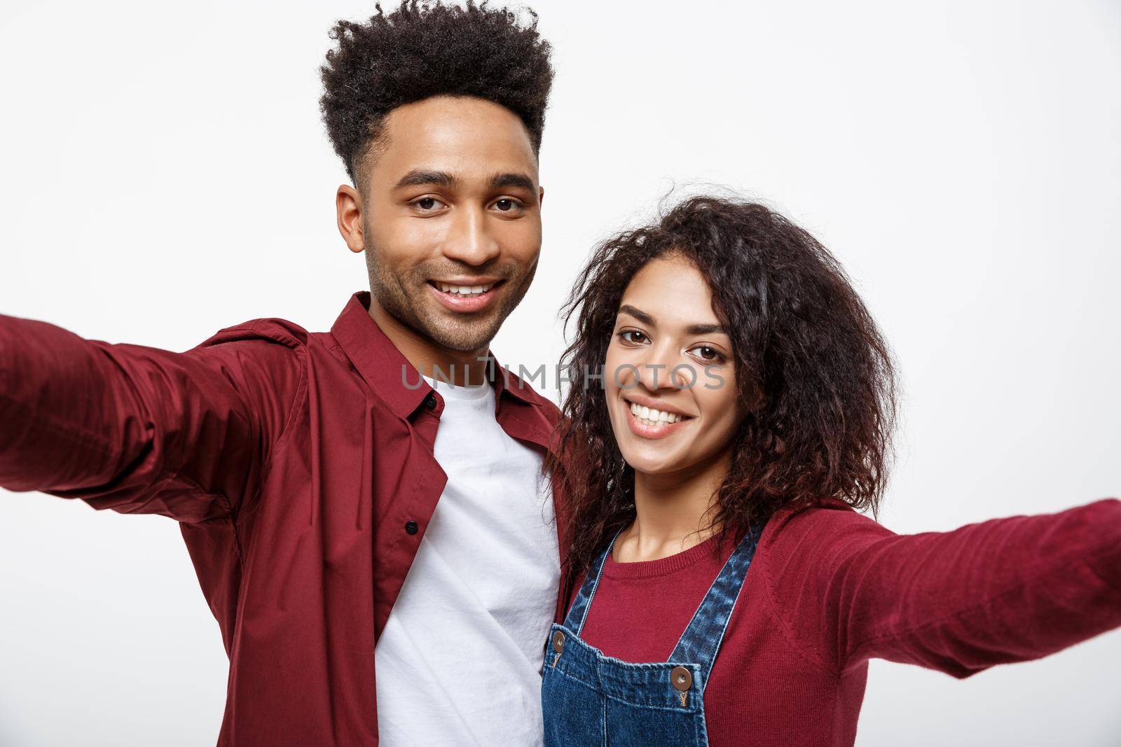 Close up attractive African American couple making a selfie with cute gesture