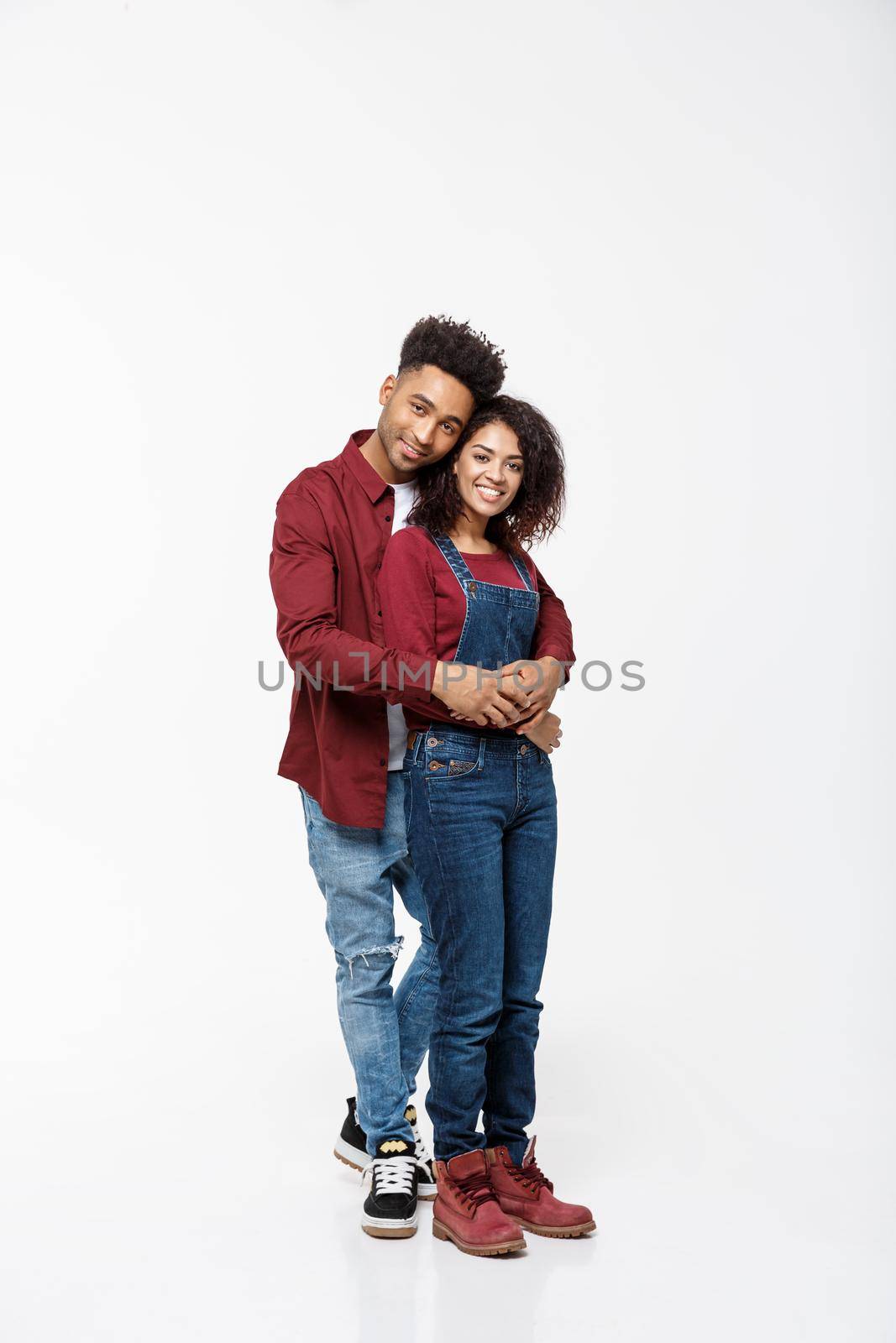 Full body portrait of young African American hugging couple, with smile. Dating, flirting, lovers, romantic studio concept, isolated on white background. by Benzoix