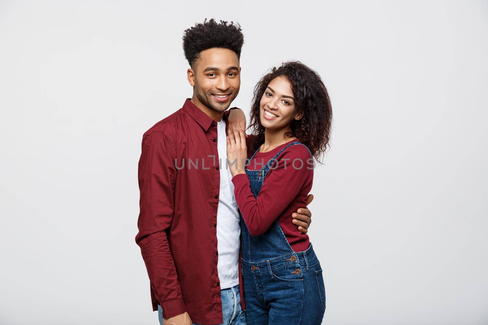 portrait of happy african american couple hug each other on white background