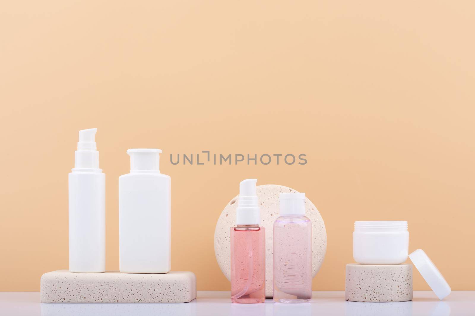 Set of skin care products on neutral stone podiums against beige background with copy space. Concept of daily skin care  by Senorina_Irina