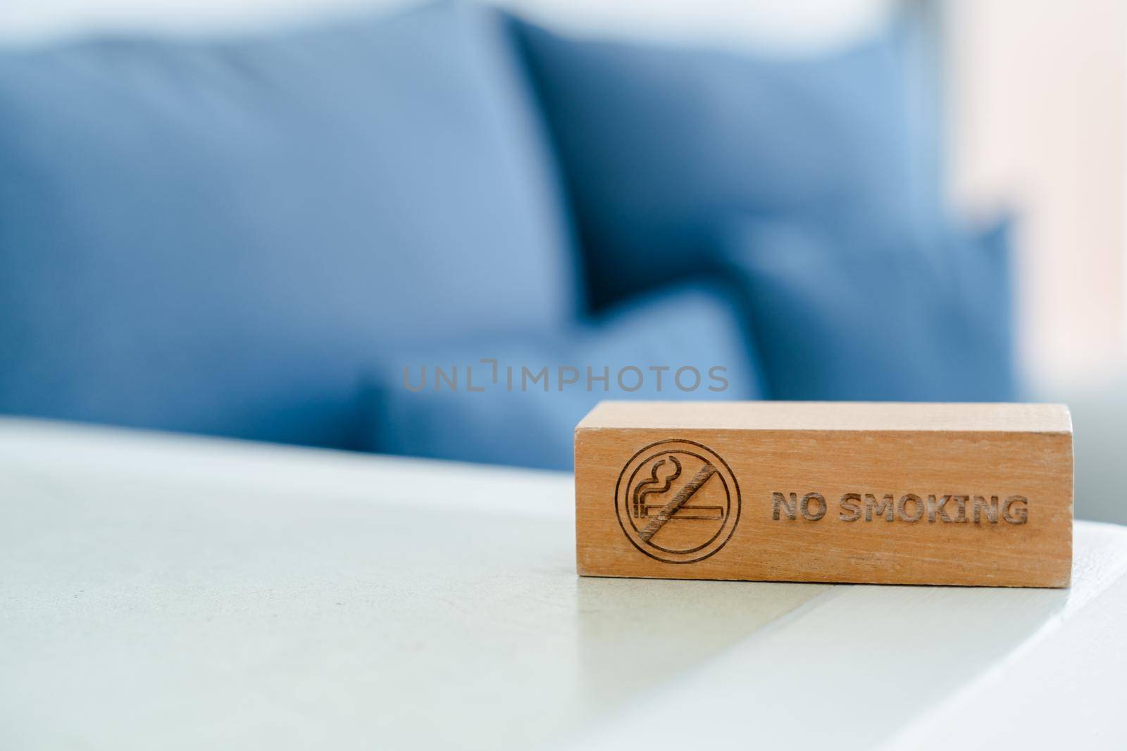 No smoking sign written on wood panel.