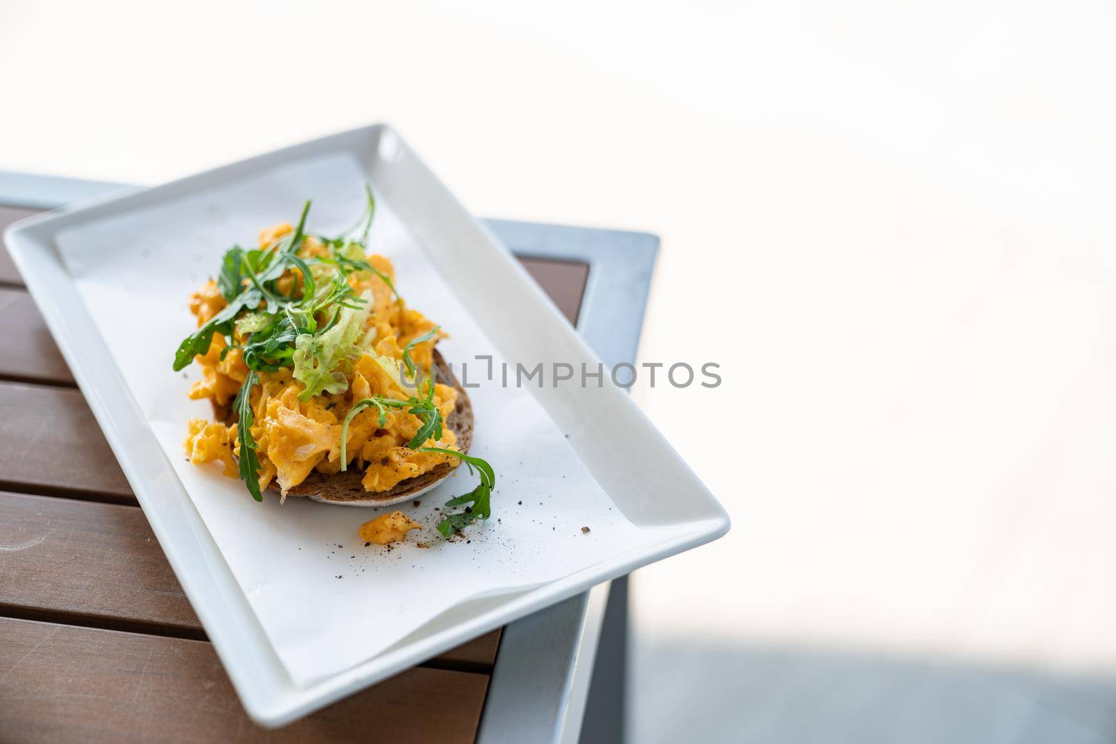 Homemade Scrambled eggs with herbs on wheat bread. by sirawit99