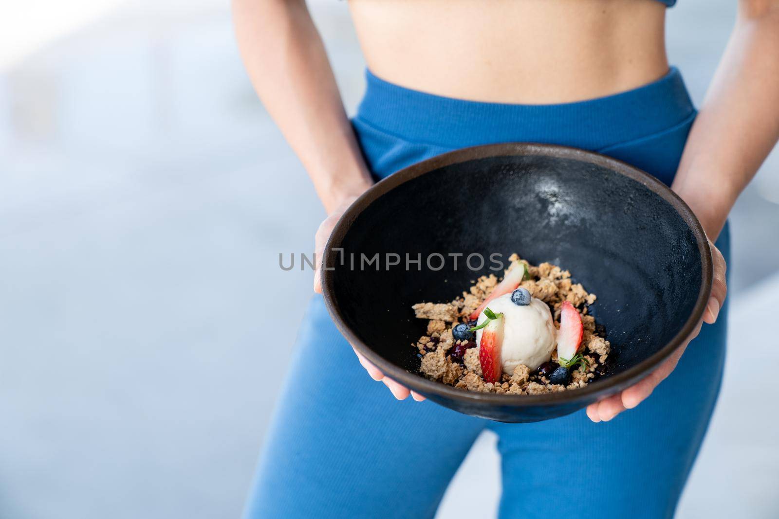 Woman served ice cream bowl with fruit and granola. by sirawit99