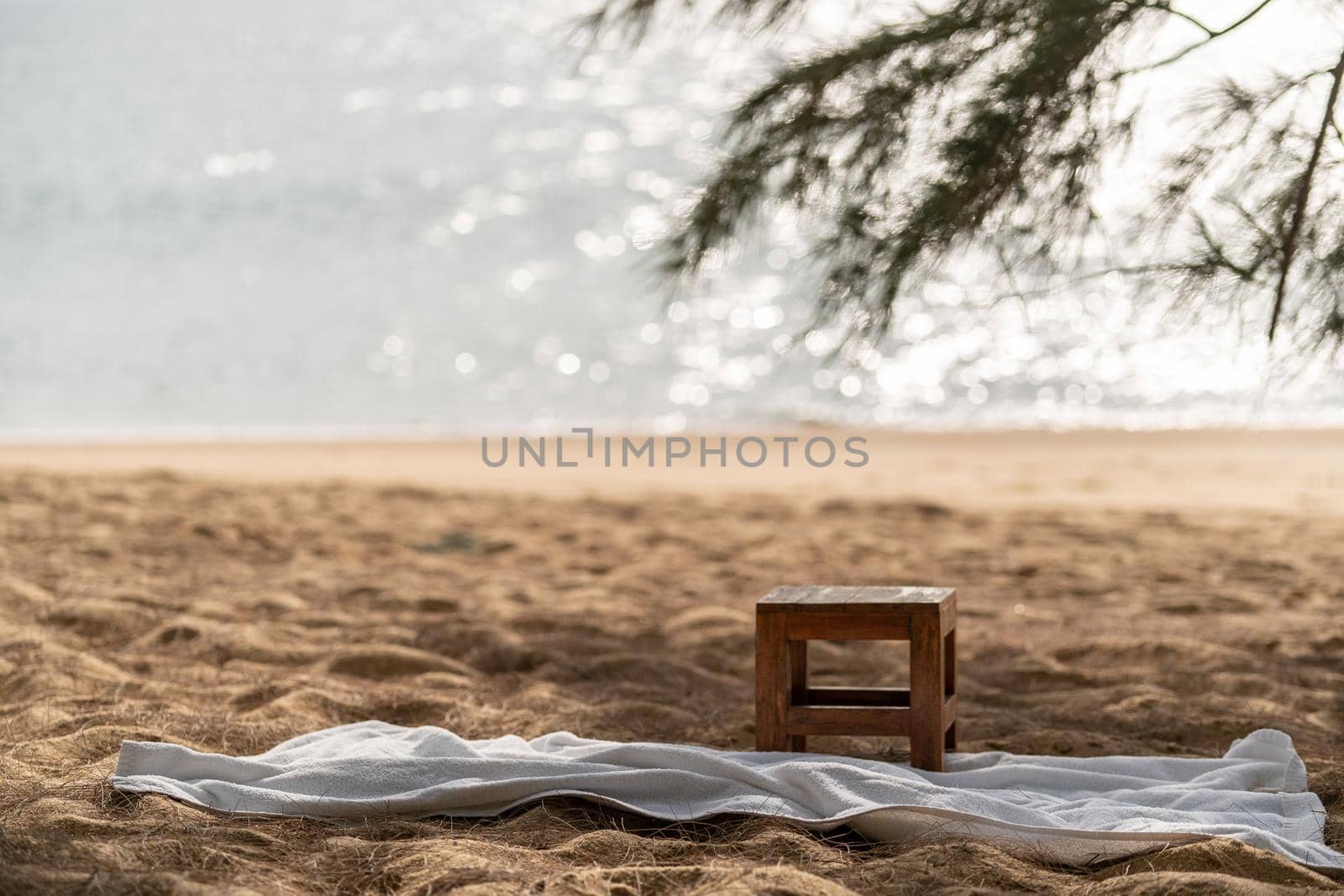 Wooden chair and white towel on the beach, ocean background. by sirawit99