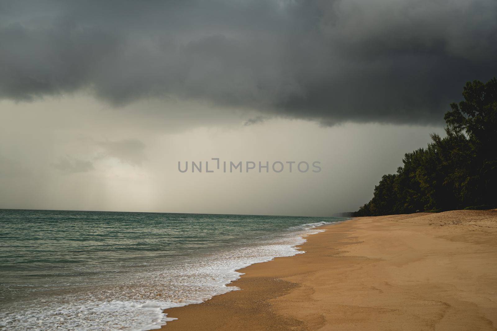 Tropical beach with white sand and dark storm clouds. by sirawit99