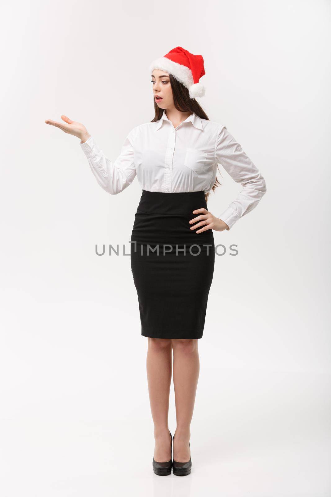Business Concept - Modern caucasian business woman in the white studio background holding hand onside presenting product.